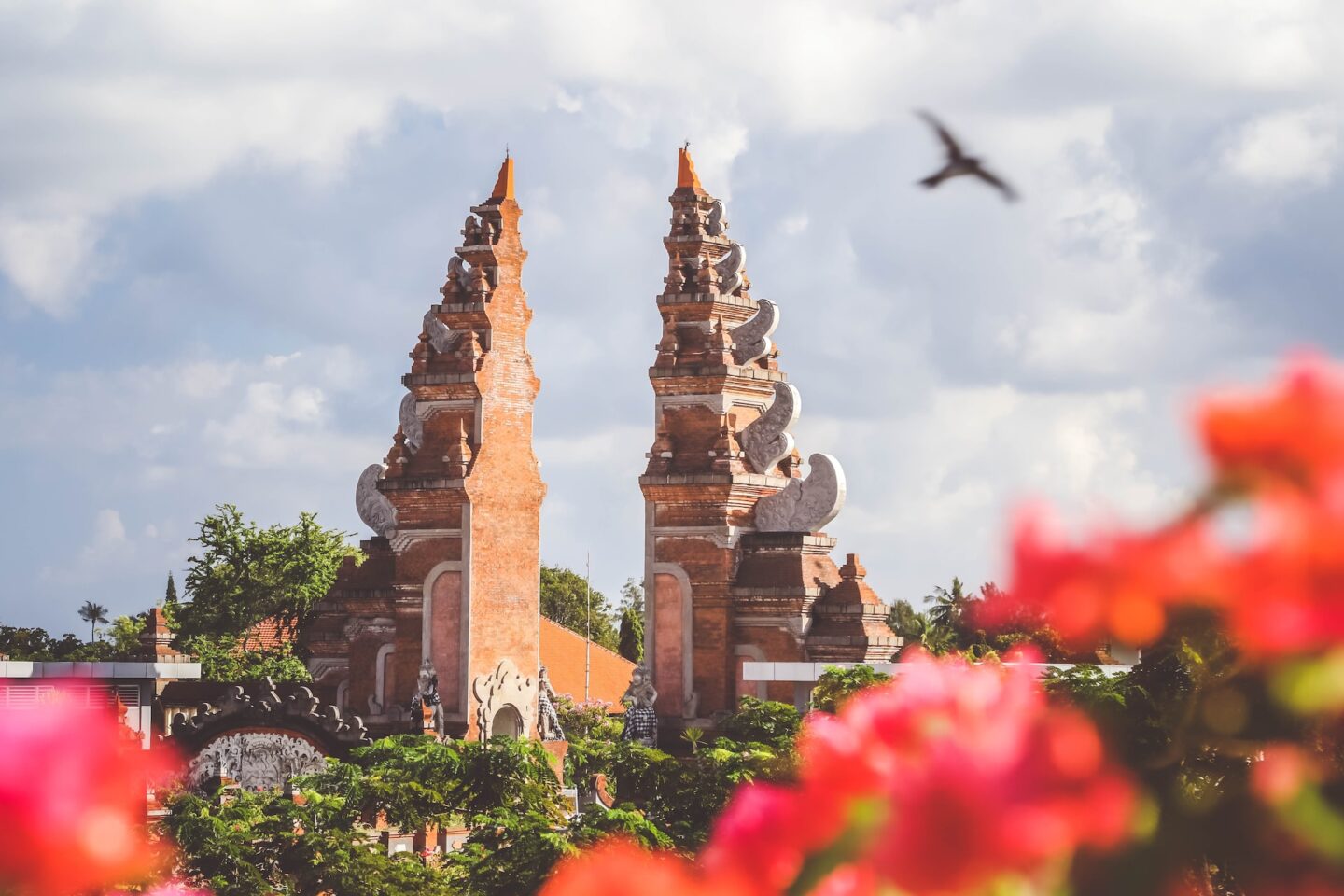 temple bali with red flowers and birds