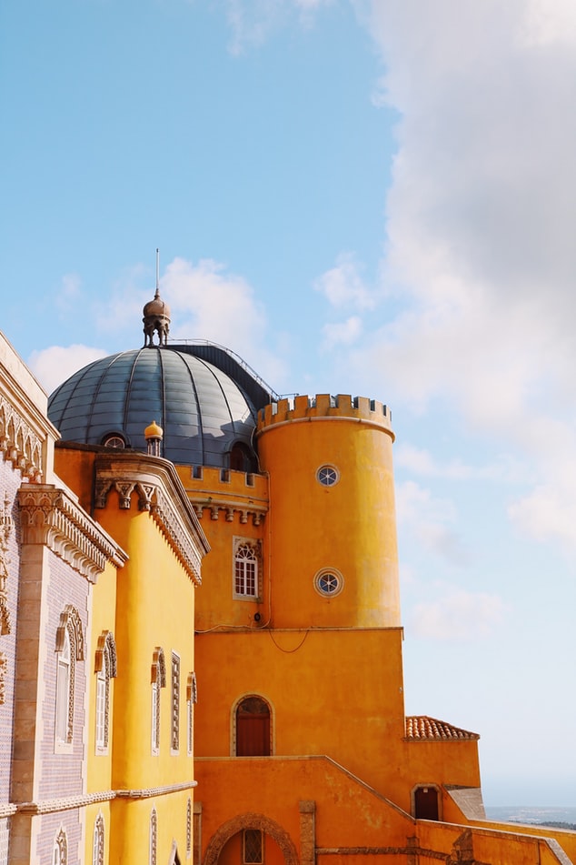 yellow castle in sintra in portugal, fairy tale villages to visit worldwide, travel inspiration