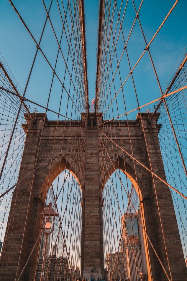 the brooklyn bridge in new york city on a sunny day with skyscrapers in the background