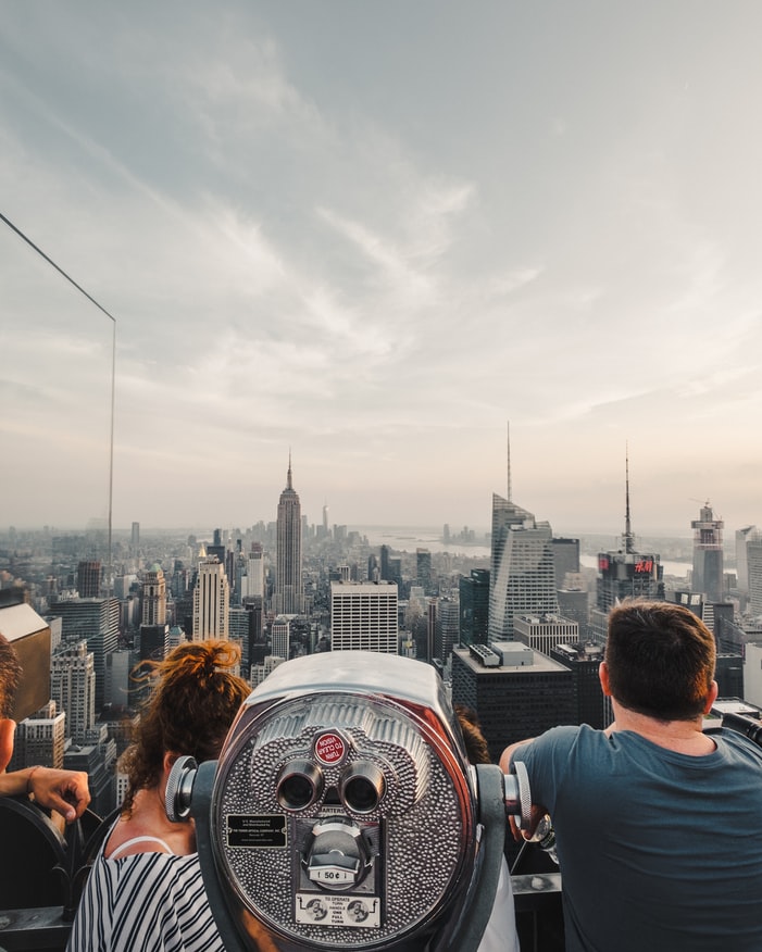a view from the rooftop over the skyline of new york city during golden hour