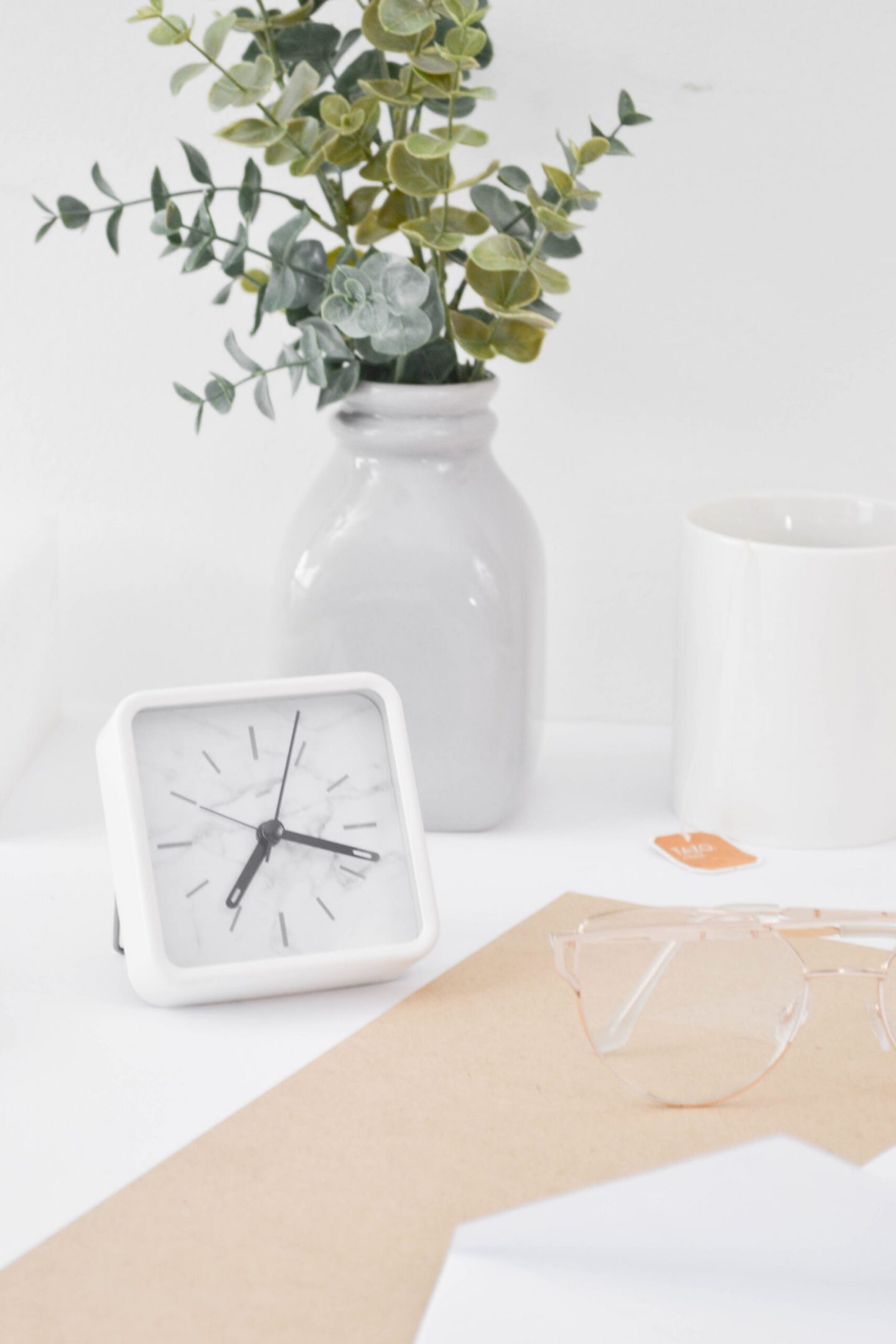 a desk with desk essentails and a notebook for blogging