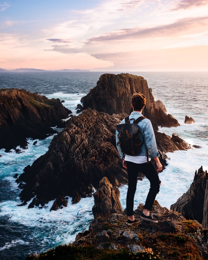 a man standing with rocks and