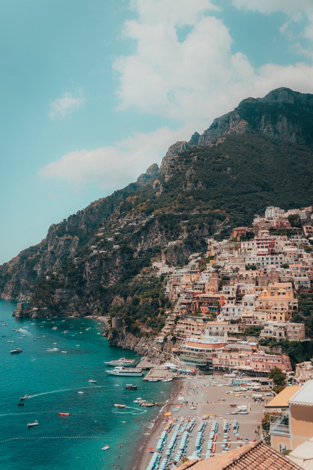 view over a town in italy, ocean view and village on a mountain