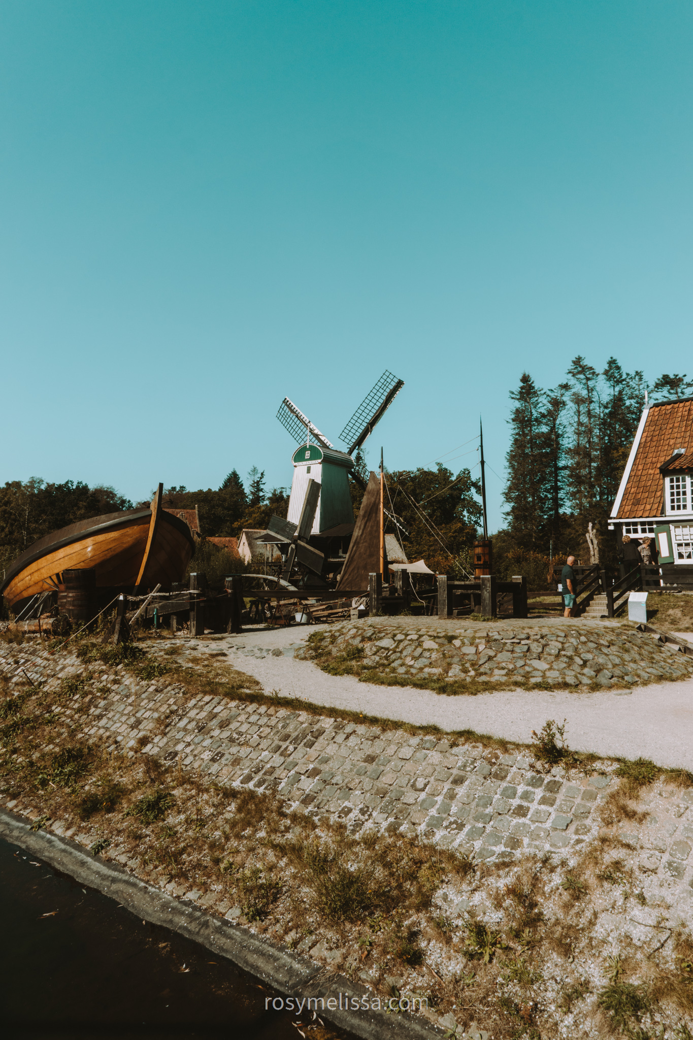 view on the nature in openluchtmuseum, view on a windmill and typical dutch houses